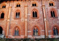 Red facade with nine wonderful mullioned windows in the castle of Vigevano near Pavia in Lombardy (Italy)