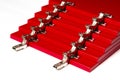 The red facades for the chest of drawers with metal loops lie on a white background. installation of furniture