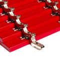 The red facades for the chest of drawers with metal loops lie on a white background. installation of furniture