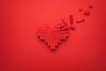 Red falling apart heart symbol made of plastic building blocks