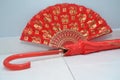 A red fan and umbrella used in traditional asian chinese weddings Royalty Free Stock Photo