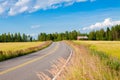 Red farm with the road, blue sky and green field Royalty Free Stock Photo