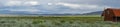 Red farm shed in a big grassland farm field Royalty Free Stock Photo