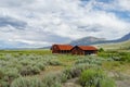 Red farm shed in a big grassland farm field Royalty Free Stock Photo