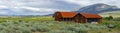 Red farm shed in a big grassland farm field Royalty Free Stock Photo