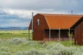 Red farm shed in a big grassland farm field Royalty Free Stock Photo