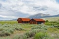 Red farm shed in a big grassland farm field Royalty Free Stock Photo