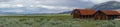 Red farm shed in a big grassland farm field Royalty Free Stock Photo