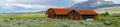 Red farm shed in a big grassland farm field Royalty Free Stock Photo