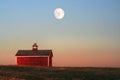 Red farm shed with cupola atop a hill with bright full moonrise above Royalty Free Stock Photo