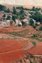 Red farmland with village in dongchuan of china Royalty Free Stock Photo