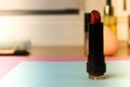 Red fashionable lipour lipad, and highlighter on the background of a beauty makeup table Royalty Free Stock Photo