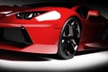 Red fast sports car in spotlight, black background. Shiny, new, luxurious. Royalty Free Stock Photo