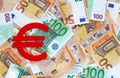 Red felt Euro currency symbol on 50 and 100 euro banknotes background. Financial, money, concept.