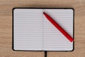 Red felt tip pen on open notebook Royalty Free Stock Photo