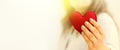 Red felted heart in femaile hands with rainbow manicure. Love, valentine, lgbt, pride concept Royalty Free Stock Photo