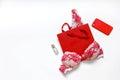 Red female erotic underwear and female accessories on a white background. Place for text. Gift concept for beloved woman