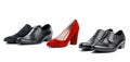 Red female shoe between black male shoes in range Royalty Free Stock Photo