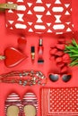 Red feminine accessories travel shopping planning packing concept flatlay.