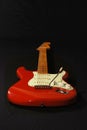 Red Fender copy guitar.