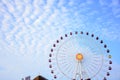 Ferris wheel under the cloudy sky.