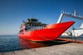 Red ferry boat with an open ramp and empty deck, moored to the harbour, Thassos Island, Greece Royalty Free Stock Photo