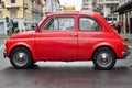 Red Fiat 500 under the rain