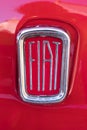 Red Fiat Cinquecento 500 vintage red shiny metal exterior badge.