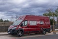 A Red Fiat Ducato Campervan parked on the side of the street