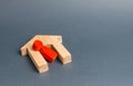 Red figurine of a man and a fallen house on a gray background. Concept of accident or disaster. The consequences of the war