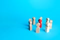 Red figurine of a man surrounded by people. Leader and significant person, important. Uniting around a team of people. Cooperation Royalty Free Stock Photo