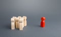 Red figurine person and crowd of people standing separately. Leader and leadership skills. Cooperation, collaboration. Fear