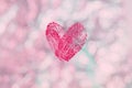 Red fingerprint heart for Valentines Day on light pink bokeh background, wallpaper for Women`s Day, marriage, wedding invitation