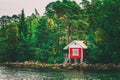 Red Finnish Wooden Bath Sauna Log Cabin On Island In Summer