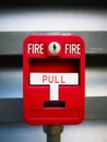 Red fire alarm box, is on grey metal wall for warning and securi Royalty Free Stock Photo