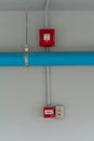 Red Fire alarm lighting above PVC pipe against white background Royalty Free Stock Photo