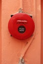 Red fire alarm on orange wall Royalty Free Stock Photo