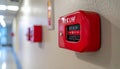 Red fire alarm pull station on beige wall in hospital corridor with digital display Royalty Free Stock Photo