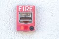 Red fire alarm switch at cement wall Royalty Free Stock Photo