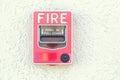 Red fire alarm switch at cement wall Royalty Free Stock Photo