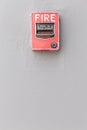 Red fire alarm switch on exterior cement wall of commercial building, safety concept. Royalty Free Stock Photo