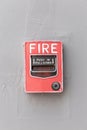 Red fire alarm switch on exterior cement wall of commercial building, safety concept. Royalty Free Stock Photo