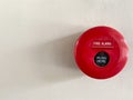 Red fire alarm switch on the white concrete wall in the building. Royalty Free Stock Photo