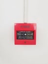 Red fire alarm on the white wall Royalty Free Stock Photo