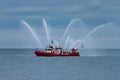 Red Fire boat with Active Water Canons Royalty Free Stock Photo