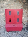 Red fire box with water hydrant on stone pavement on wall background Royalty Free Stock Photo