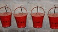 Red Fire Buckets Hanging on Wall Royalty Free Stock Photo