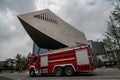 Red fire engines parked in front of a modern building in wuhan city
