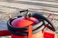 Red fire extinguisher and hose close up Royalty Free Stock Photo