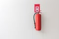 Red Fire extinguisher on the white wall background Royalty Free Stock Photo
